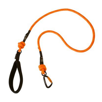 An orange rope dog leash with black webbing handle, black knots, and a black  carabiner clip, with Fell Dog branding